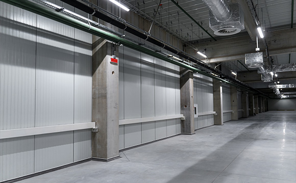 interior of a modern warehouse showing six storage bays and concrete flooring with industrial lighting