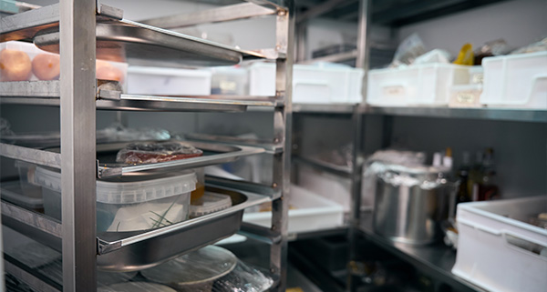 organized commercial kitchen storage with trays and containers showcasing five food items