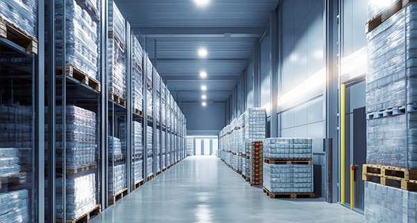 warehouse interior with stacked pallets and rows of shelves showcasing organized storage for efficient logistics operations