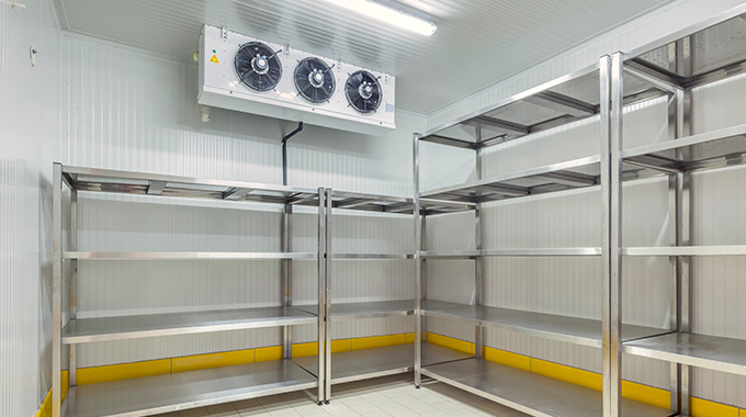 interior of a storage room with metal shelves and industrial cooling system designed for efficient organization and temperature control in a commercial setting appropriate for two temperature zones