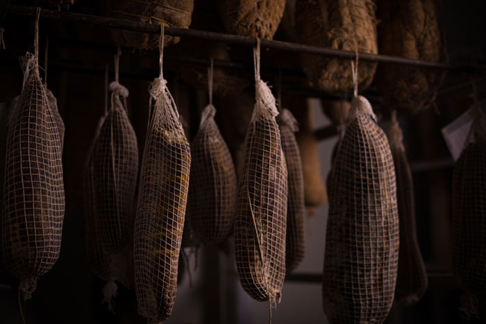 Cured meat hanging in a cold room